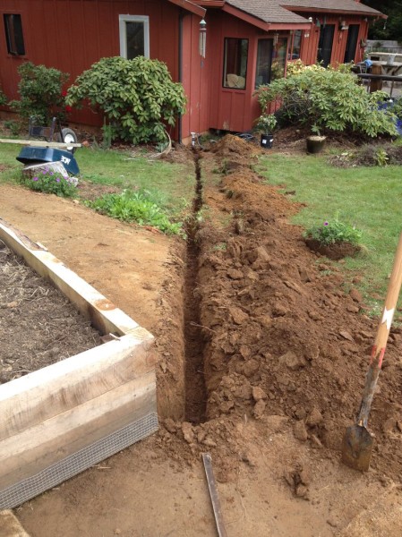 This trench begins at the water source next to the house and runs to the corner of the nearest bed