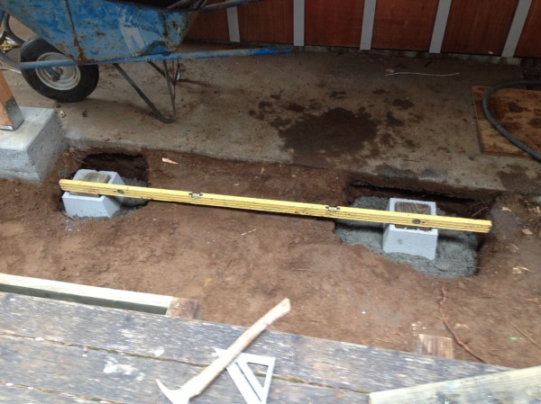 We had to set a couple of pier blocks in the ground so the step would have a firm, level surface to sit on