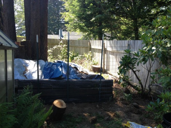 Extended retaining wall and fence to close off the last gap