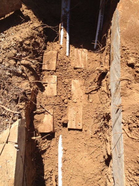 Bricks and dirt to cover pipes