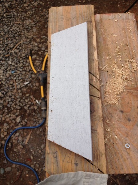 Bat cut at two different angles so as to be flush with the bottom of the siding as well as the roof overhang