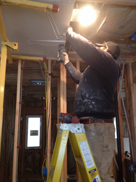 Sean cutting a hole for a heating vent
